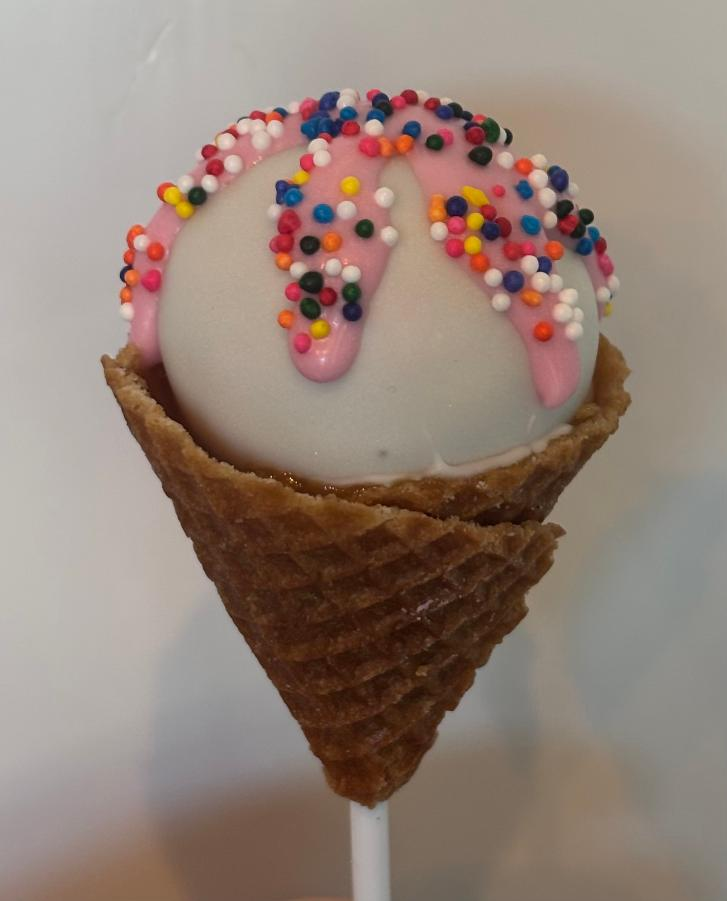 Single ice cream cone cake pop with colorful sprinkles