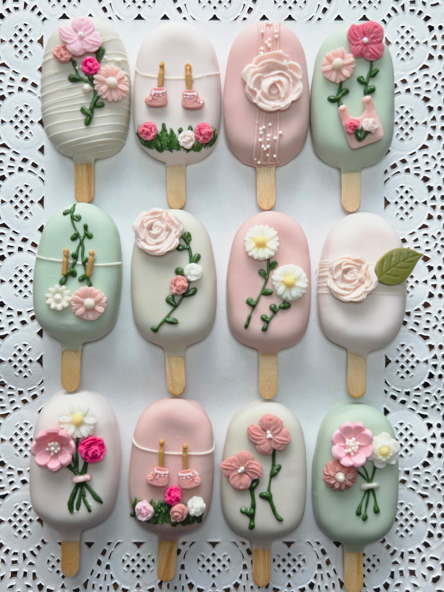 Elegant floral baby shower cakesicles in pink, sage, and cream