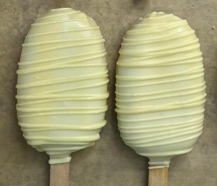 Creamy lemon cakesicles with white drizzle